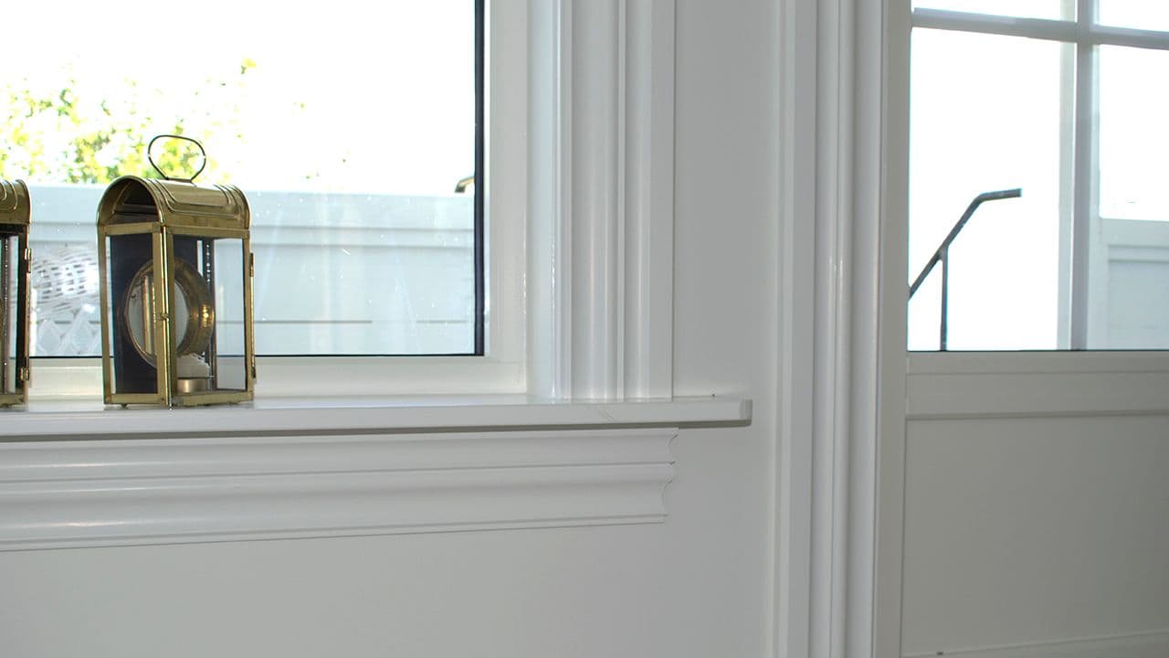 Hjem med brede lister rundt vinduer.