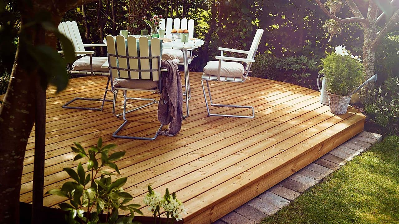 Platting i farge fra årets terrassebeis fargekart med hvite hagemøbler.